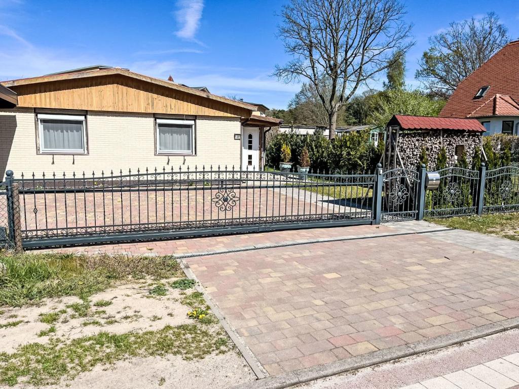 a wrought iron fence in front of a house at Holiday Home Hammel by Interhome in Ostseebad Koserow