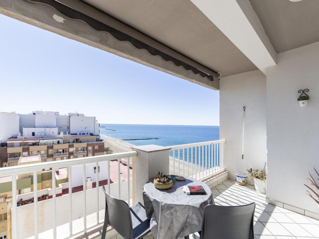 a balcony with a table and a view of the ocean at Apartment Vista Playa Zapillo by Interhome in Almería