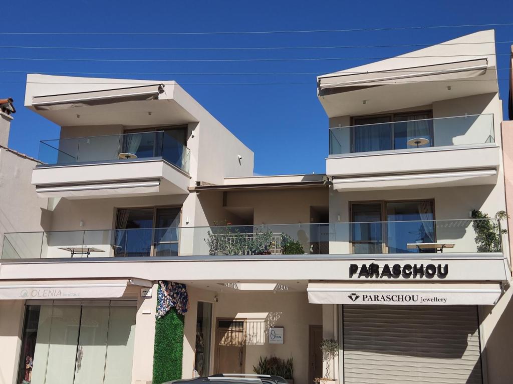 a white building with a sign for a pharmacy at Theros Summer Suite 1 in Nikiti