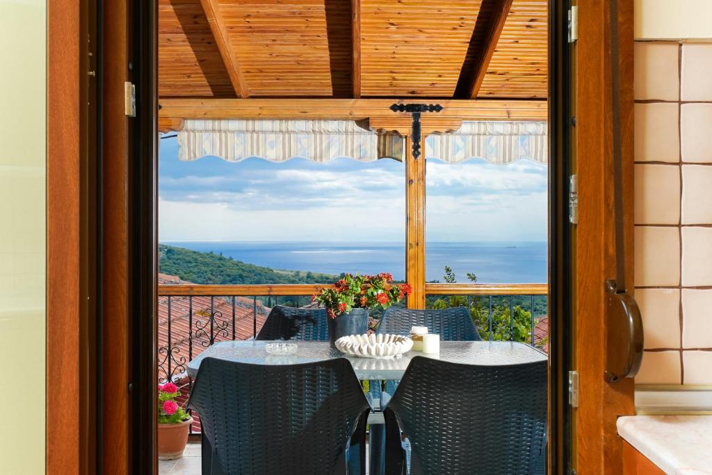 a table and chairs on a balcony with a view at Christina's Village Home in Kallirakhi