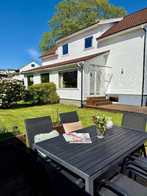 a wooden table in the yard of a house at Central family twinhouse in Stavanger