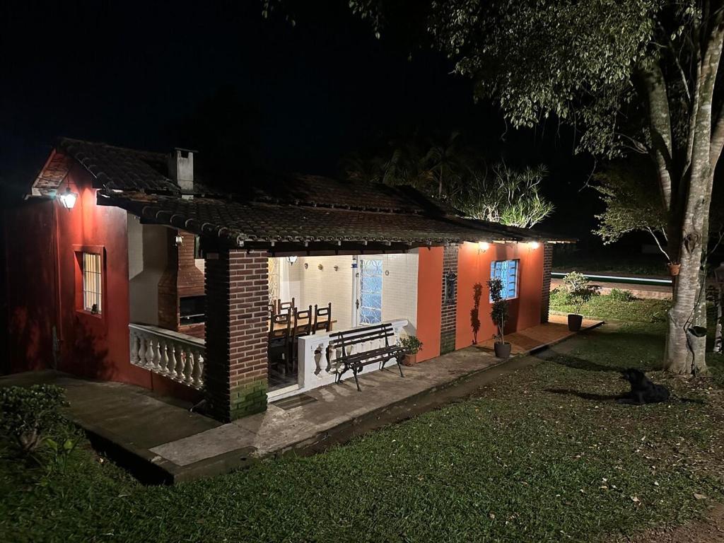 a house with a bench in front of it at night at Recanto Paraíso in Cotia