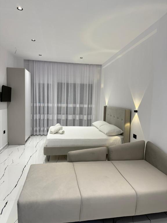 Postel nebo postele na pokoji v ubytování Maison Apartments