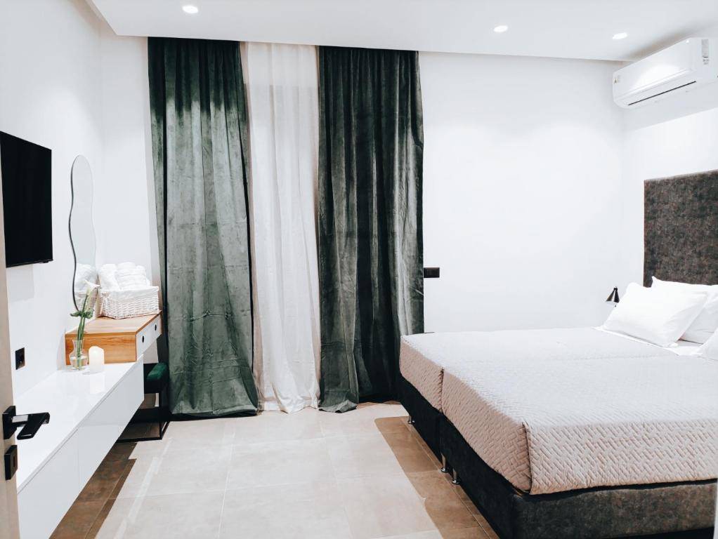 una camera da letto con un letto e una grande finestra di Azure Mirage Home Adults Only Private Seaside Villa w Garden and Parking a Faliraki