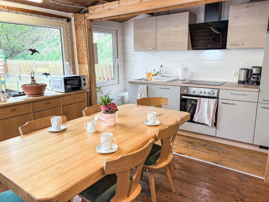 a wooden table in a kitchen with a wooden floor at Apartment Schachner-2 by Interhome in Saalbach Hinterglemm