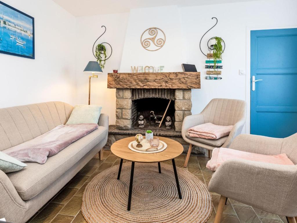 a living room with a couch and a fireplace at Holiday Home La main d'argent by Interhome in Saint-Méloir-des-Ondes
