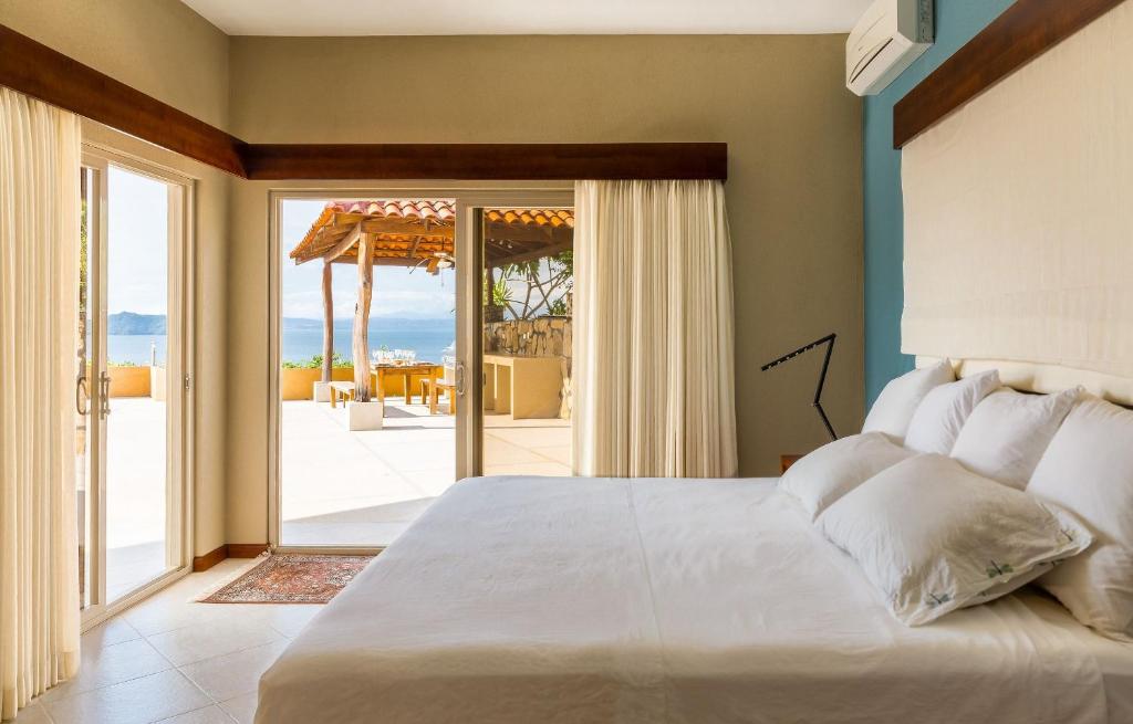 Postel nebo postele na pokoji v ubytování Villas Roma Del Mar