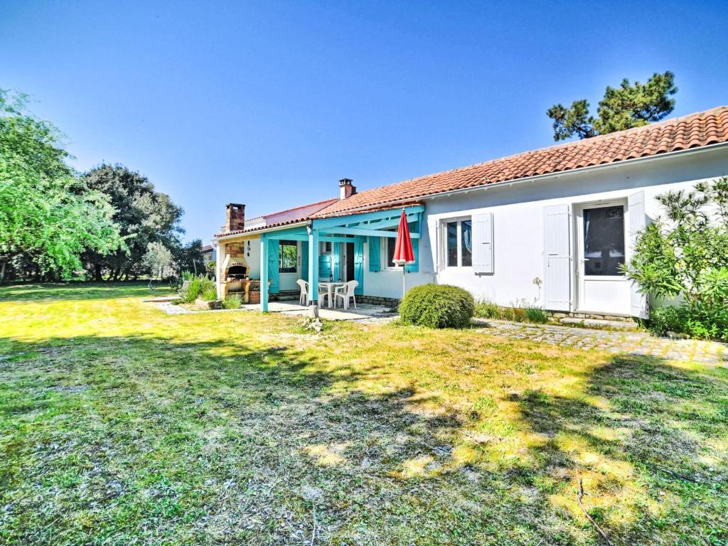 a house with a lawn in front of it at Holiday Home La Sablière by Interhome in Saint-Georges-dʼOléron