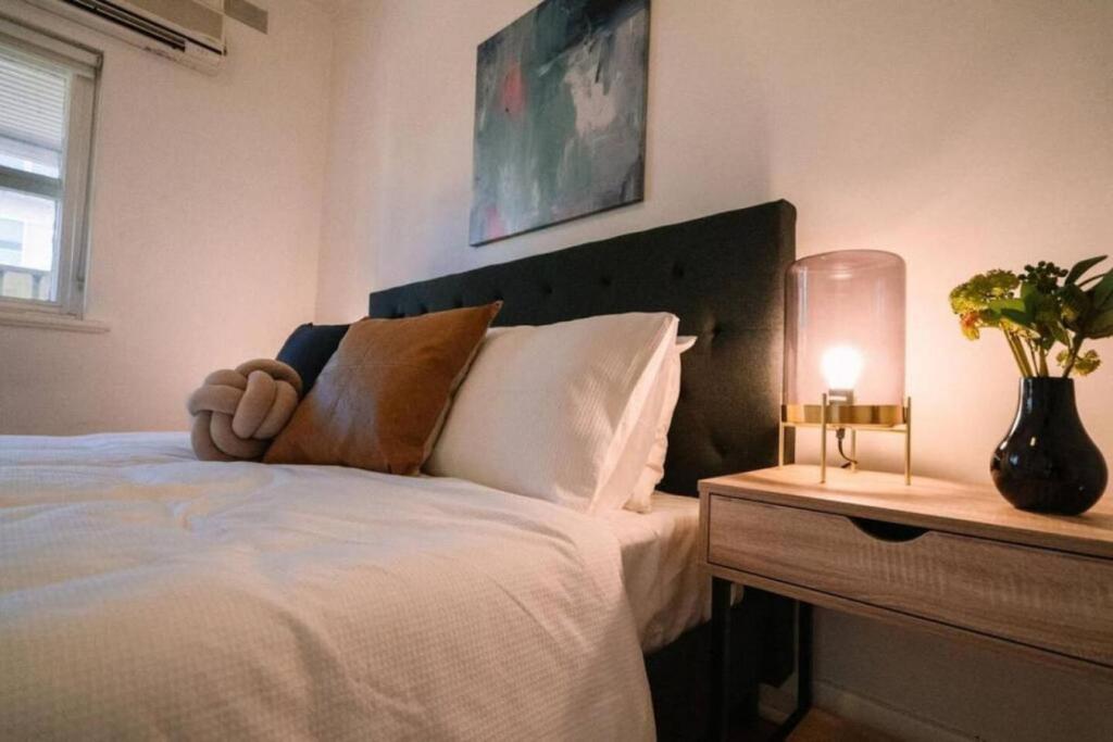 a bedroom with a bed with a teddy bear on it at 2BR unit at Glenelg Beach in Glenelg