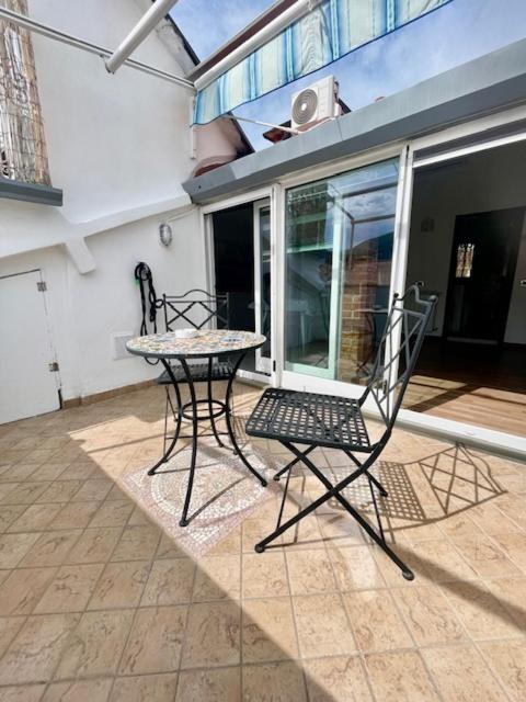 two chairs and a table on a patio at Tino'S House 2punto0 in La Spezia