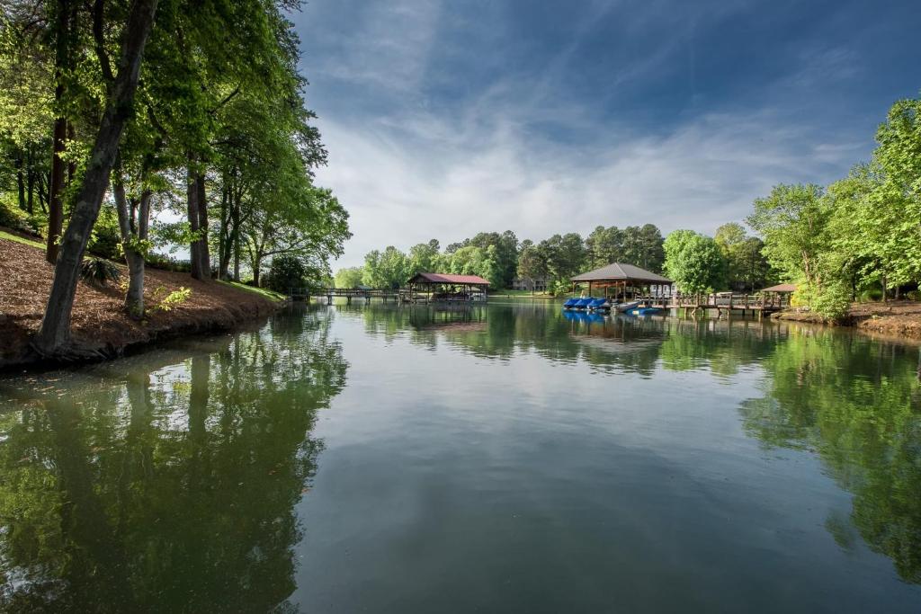 a river with boats in the middle of it at Lakeside Landing by AvantStay Private Dock in Mooresville