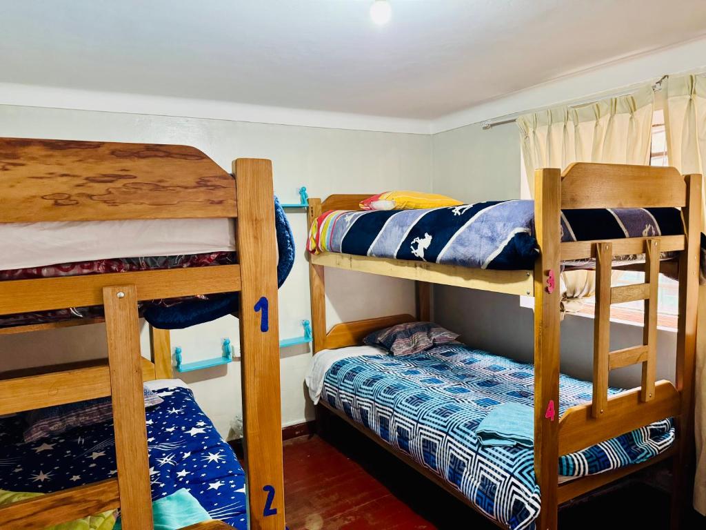 Postel nebo postele na pokoji v ubytování Ukumari Hostel