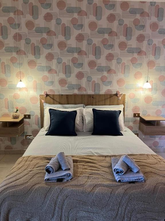 a bedroom with a bed with towels on it at Adria Art Apartments 3 in Adria