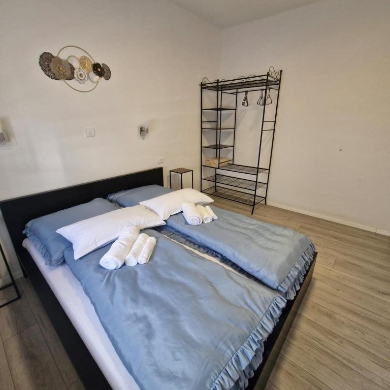 a bedroom with a bed with two white pillows at Vila Natasa Apartment 5 near Plitvice in Vrhovine