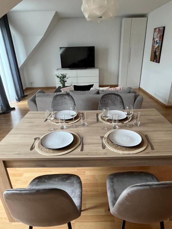 a dining room table with chairs and a couch at Alexander Home with parking in Colmar