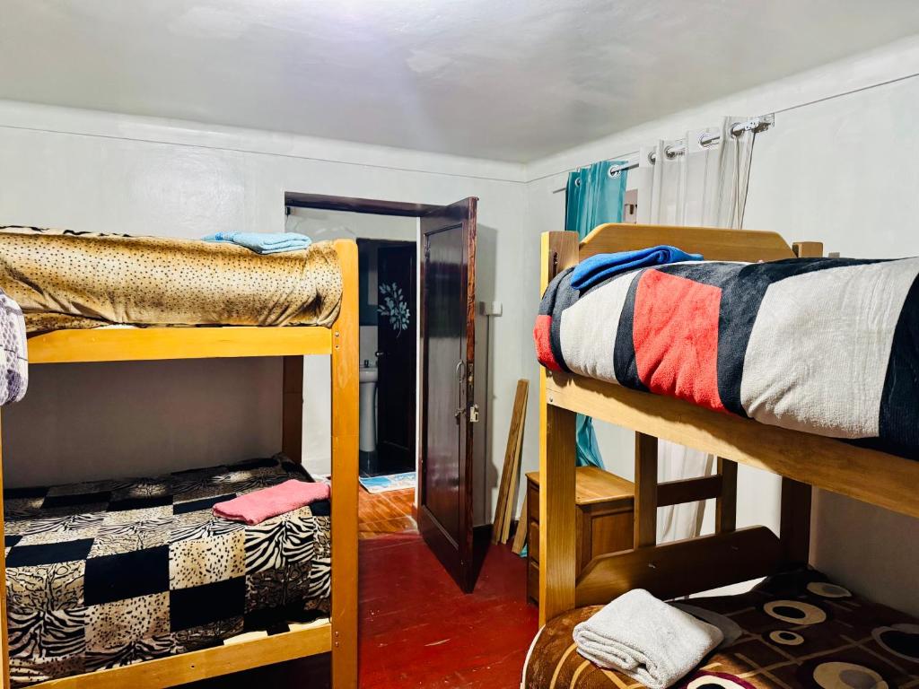 Postel nebo postele na pokoji v ubytování Ukumari Hostel