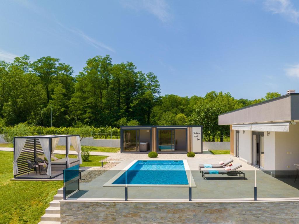 a swimming pool in a backyard with a house at Holiday Home Villa Romantica by Interhome in Nedeščina