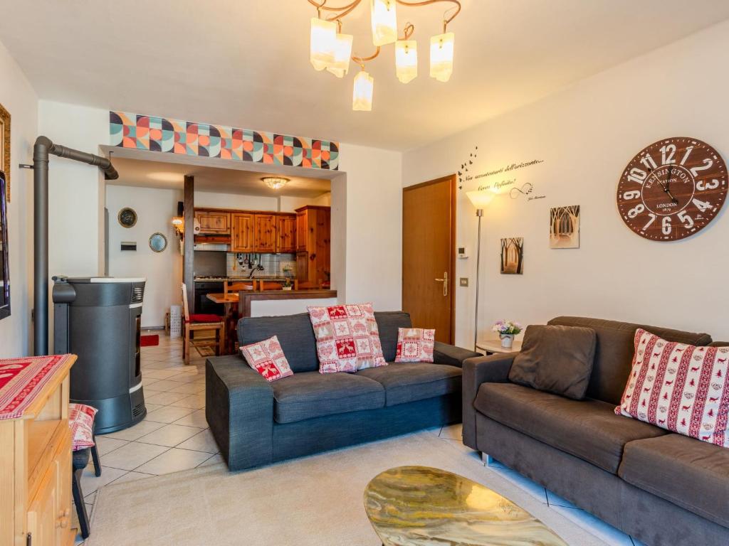 a living room with two couches and a kitchen at Apartment La Meridiana by Interhome in Spiazzo