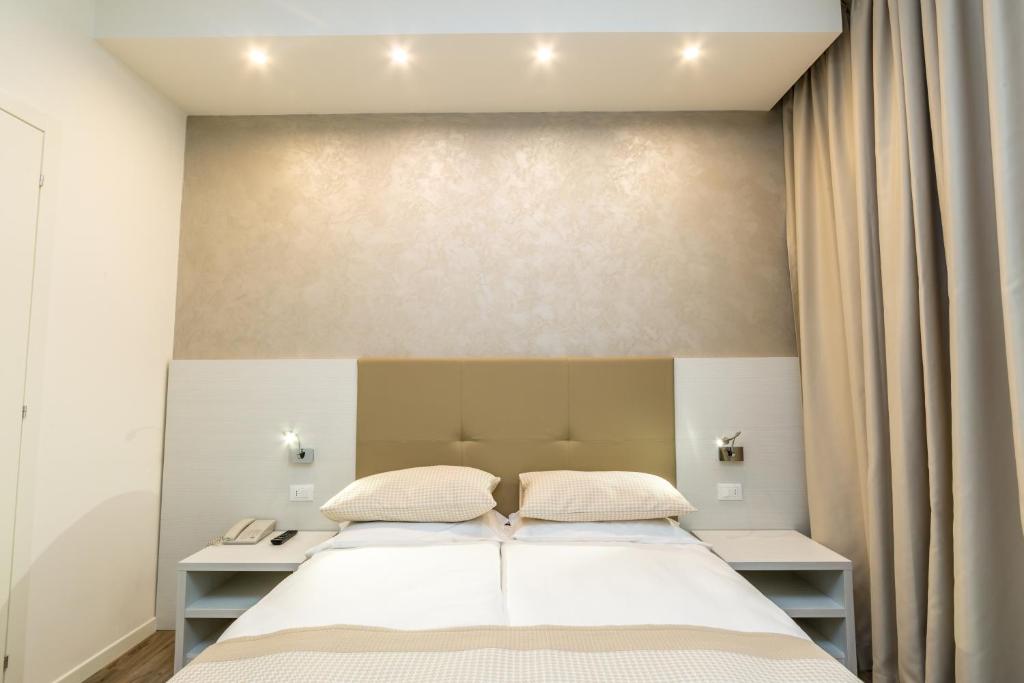 Postel nebo postele na pokoji v ubytování Hotel Touring