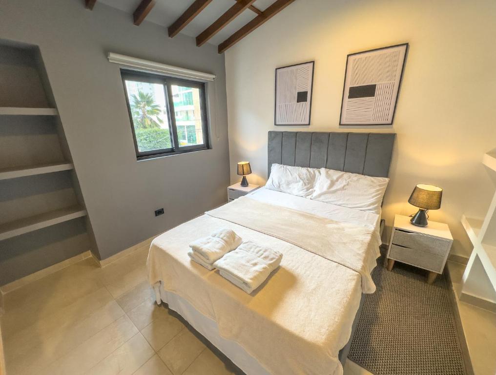 a bedroom with a bed with two towels on it at Casa Martina Manga Cartagena in Cartagena de Indias