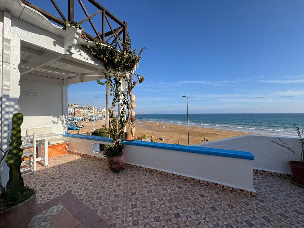 a building with a view of a beach and the ocean at Afoulki Home in Taghazout