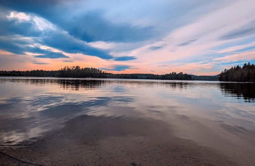a large body of water with a cloudy sky at Acadia Sunset Fishing Cabin #2 family beach fire pit in Sullivan