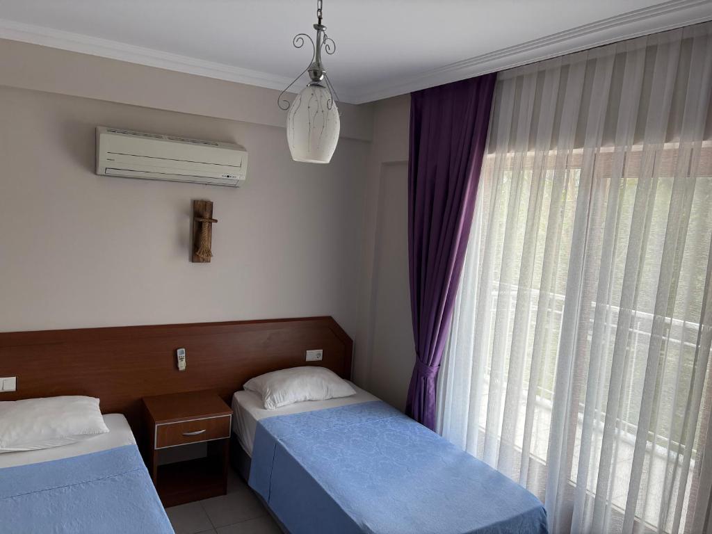 Postel nebo postele na pokoji v ubytování Ebru'ca Pansiyon