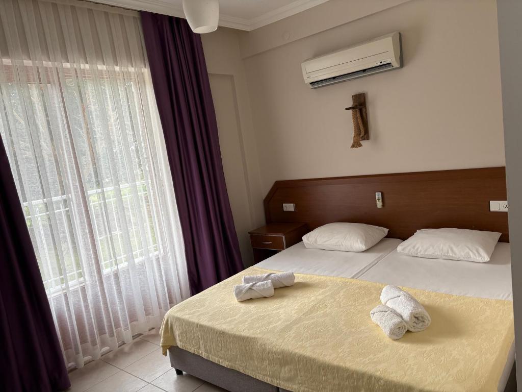 Postel nebo postele na pokoji v ubytování Ebru'ca Pansiyon