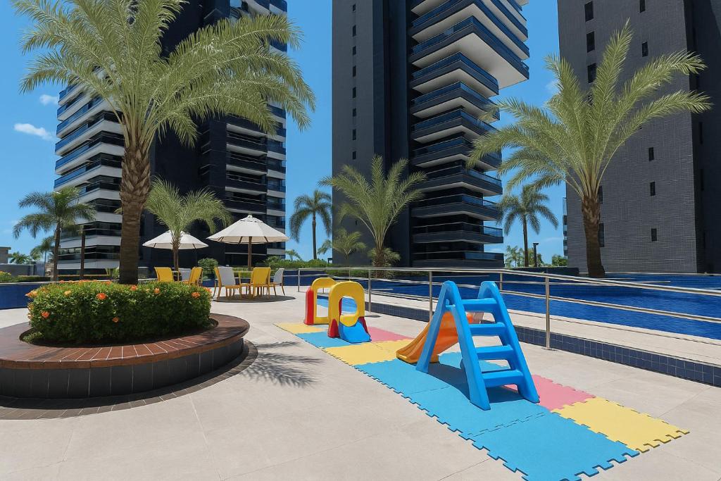 a playground in a resort with palm trees at 202 Landscape - torre Gold B in Fortaleza