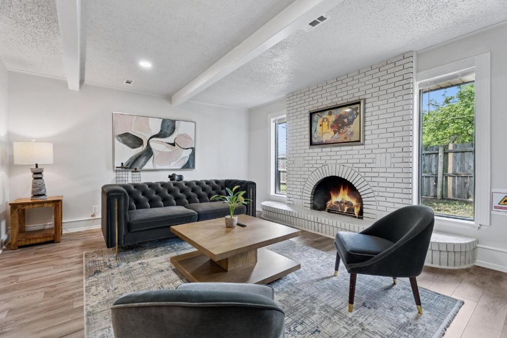a living room with a couch and a fireplace at Affordable 5br Near Route 66 Large Groups #12 in Oklahoma City