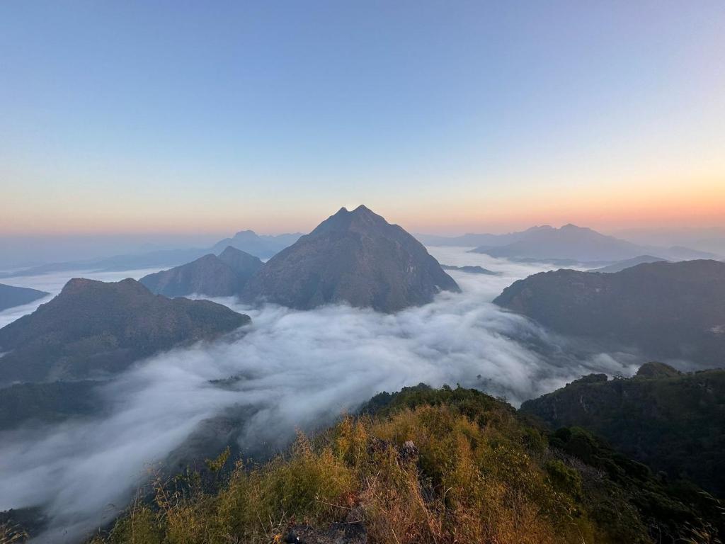 a view of a mountain range with clouds at Nongkhiaw Camping on mountain with White Rabbit tours in Ban Pho Touane