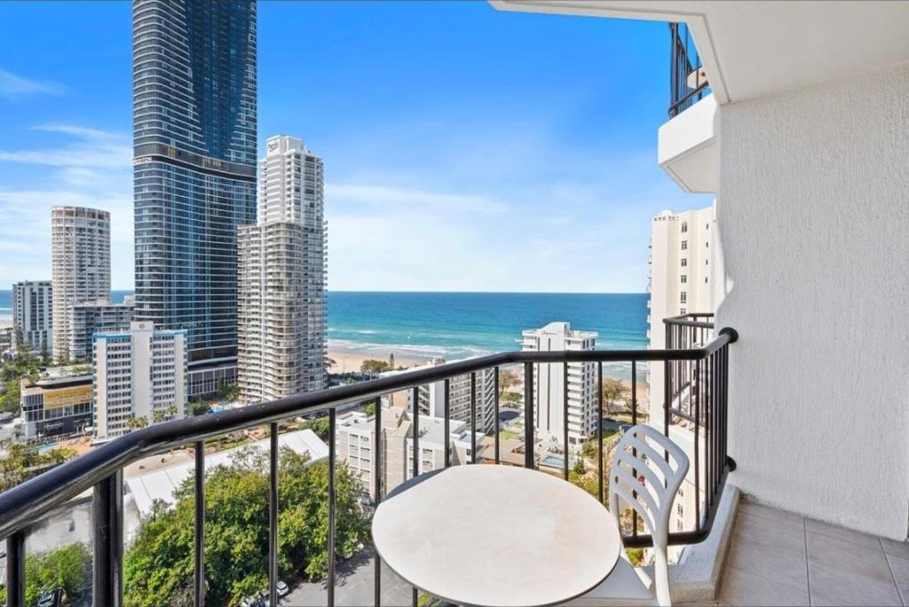 a balcony with a table and a view of the ocean at Private Hotel Rooms in Central Surfers in Gold Coast