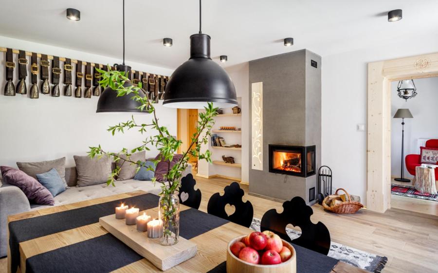 a living room with a couch and a table with candles at Holiday Home Patchwork Barn in Zakopane