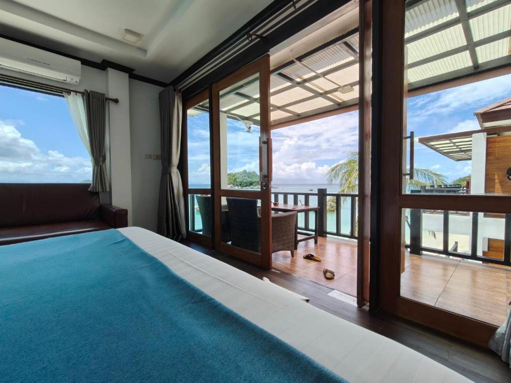 a bedroom with a bed and a view of the ocean at Cabana Lipe Beach Resort in Ko Lipe