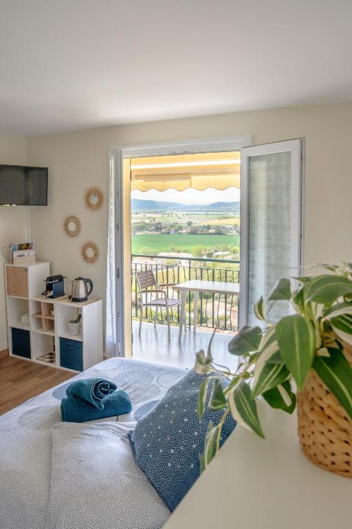 - une chambre avec un lit et un balcon dans l'établissement Lumineux studio-Gréoux-les-Bains, à Gréoux-les-Bains