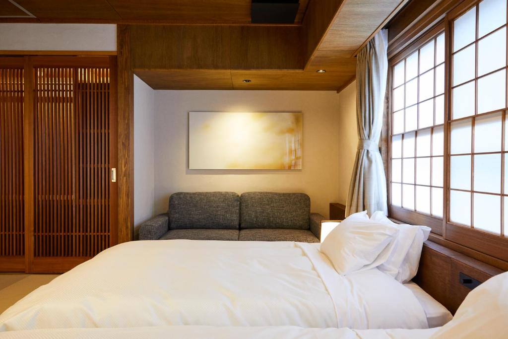 Postel nebo postele na pokoji v ubytování Ryokan Oomuraya
