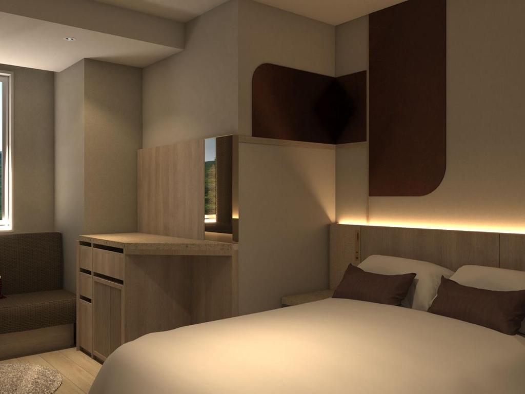 Postel nebo postele na pokoji v ubytování KAMENOI HOTEL Arima