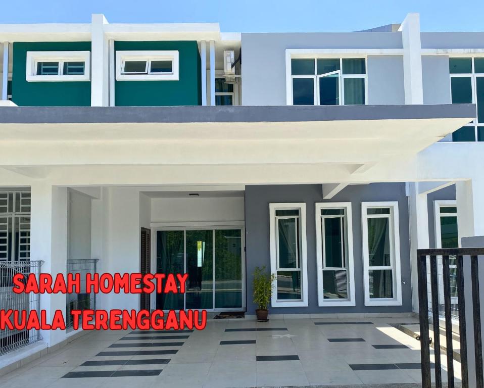 a house with a sign that reads saar homay kula terraced at Sarah Homestay in Kuala Terengganu