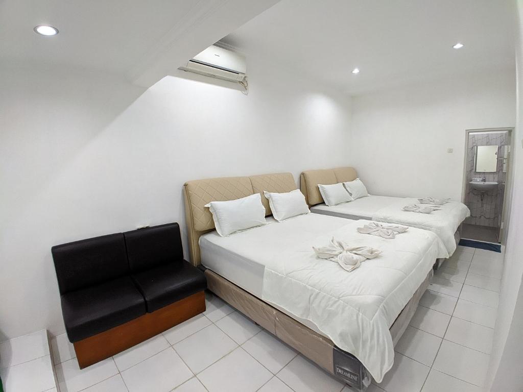 Postel nebo postele na pokoji v ubytování Hotel Bahtera PT.Pelni