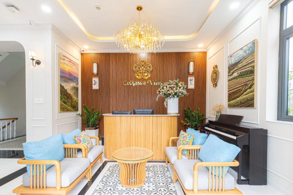 a waiting room with a piano and chairs at Cerasoi Boutique Dalat Hotel in Da Lat