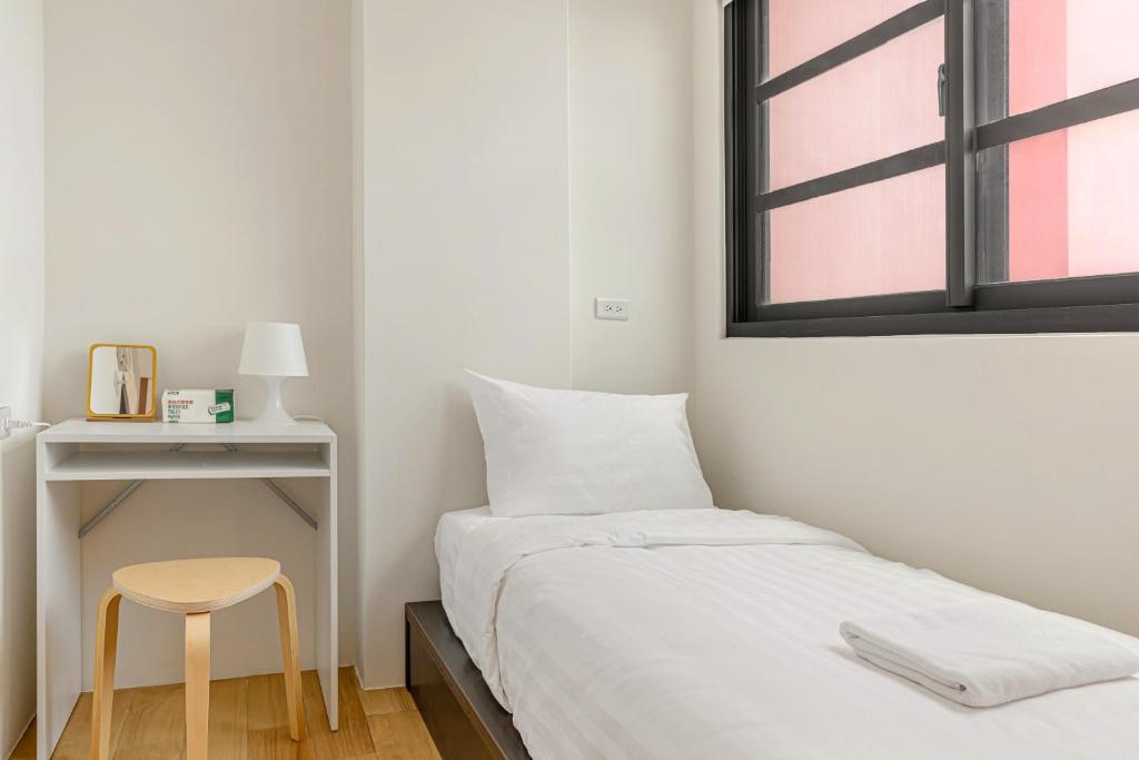 Postel nebo postele na pokoji v ubytování Hualien Unique Smart Stay with Sea View