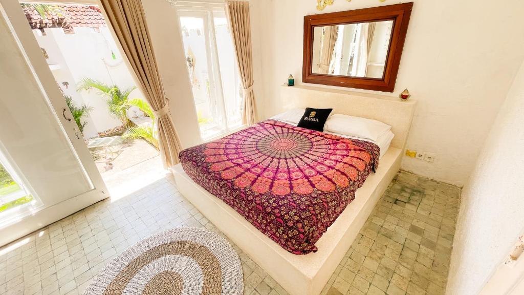 Postel nebo postele na pokoji v ubytování Surga Homestay