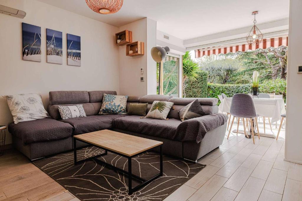un salon avec un canapé et une table dans l'établissement Marina Rey - Apt pour 4 à 400m des plages Côte d'Azur, à Villeneuve-Loubet