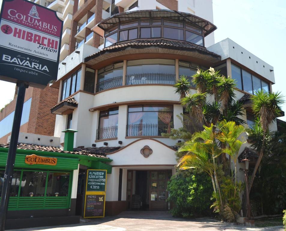 a tall building with a balcony on top of it at Hotel Columbus in San José