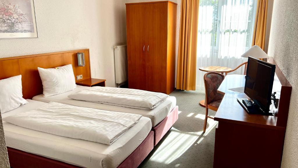 Postel nebo postele na pokoji v ubytování Hotel Siebeneichen
