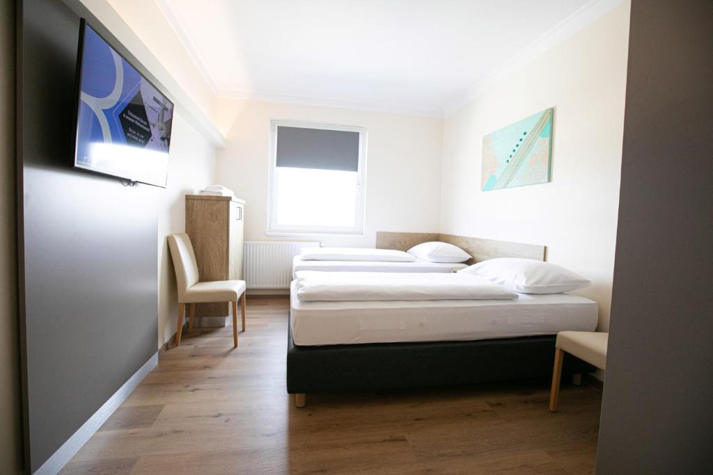 Posteľ alebo postele v izbe v ubytovaní Das Reinisch Just Rooms