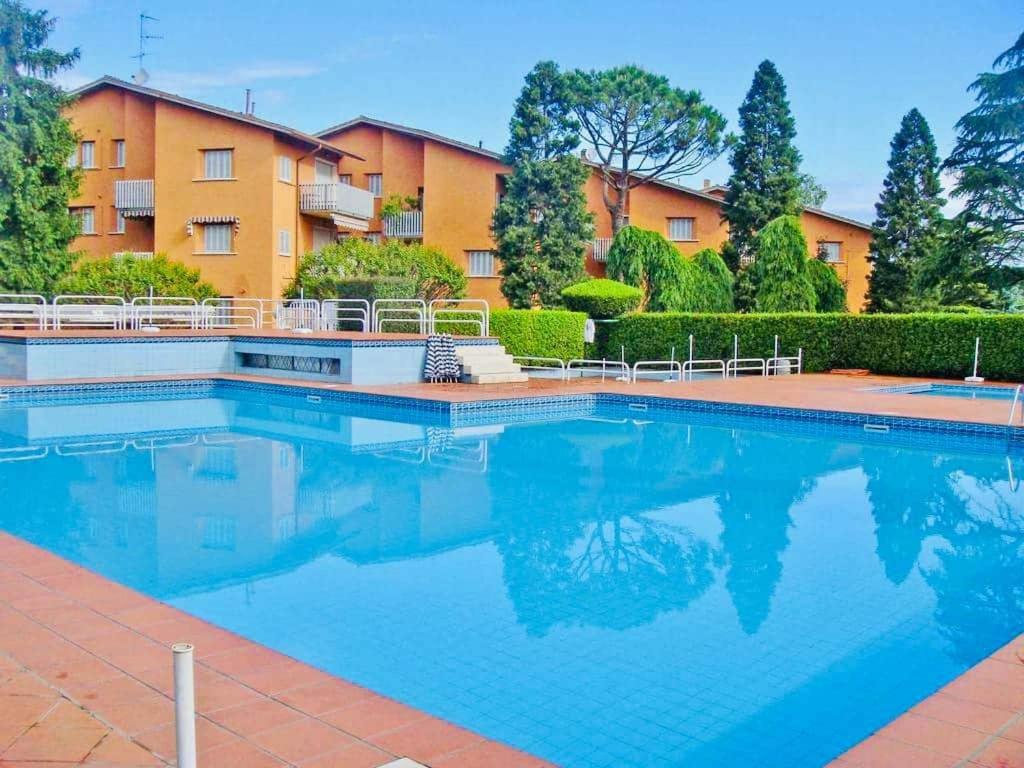 a swimming pool in front of a building at 200mt Lake - Flower Home with Pool & Tennis in Peschiera del Garda