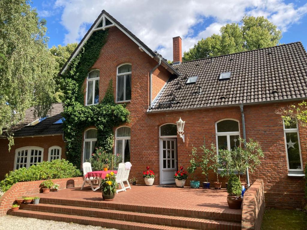 a brick house with a patio in front of it at Landhaus Amalie in Malchow