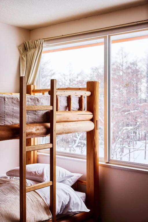 Postel nebo postele na pokoji v ubytování Canopy Lodge - Boutique Lodge at Hakuba Cortina