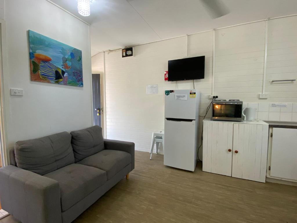 a living room with a couch and a refrigerator at The Captains Manor On Cook 5 in Arcadia